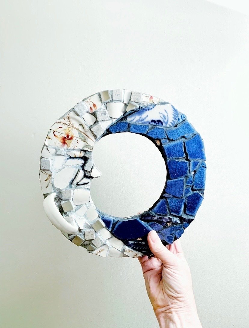 Crescent-shaped mosaic in deep blue and floral vintage china
