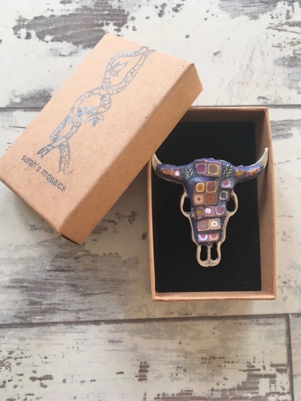 Mosaic cow skull brooch in a kraft gift box