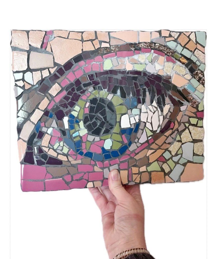 Mosaic eye in pinks, purples, greens and creams