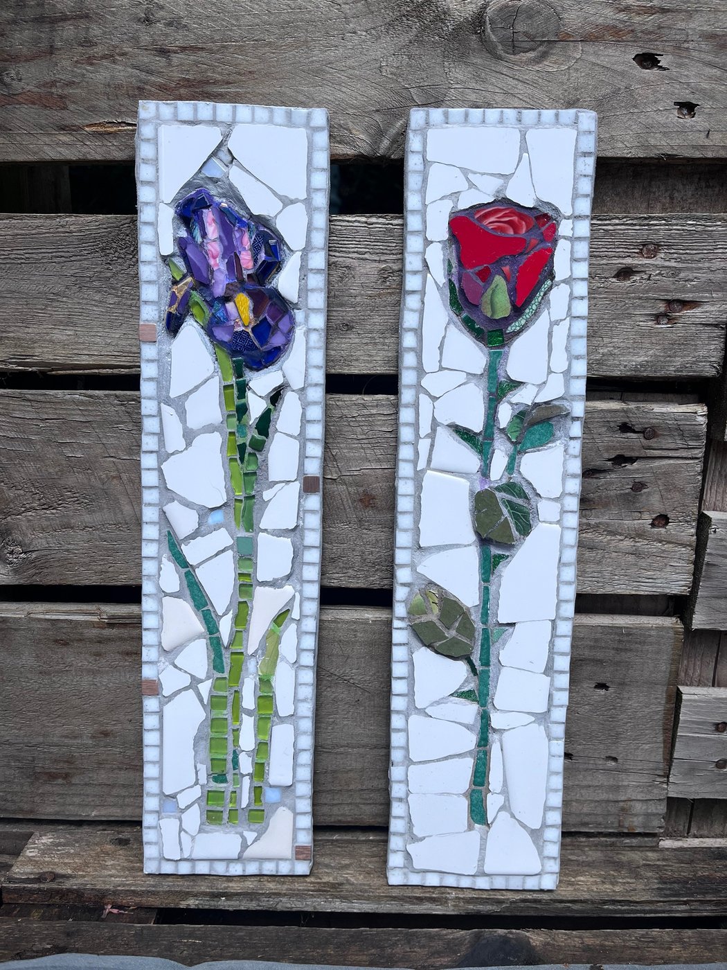 Two tall mosaic panels, one of an iris and one of a red rose