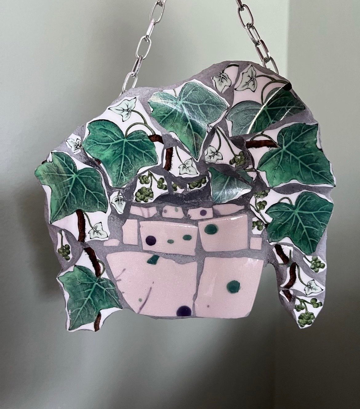 Mosaic hanging basket of trailing ivy made from broken china