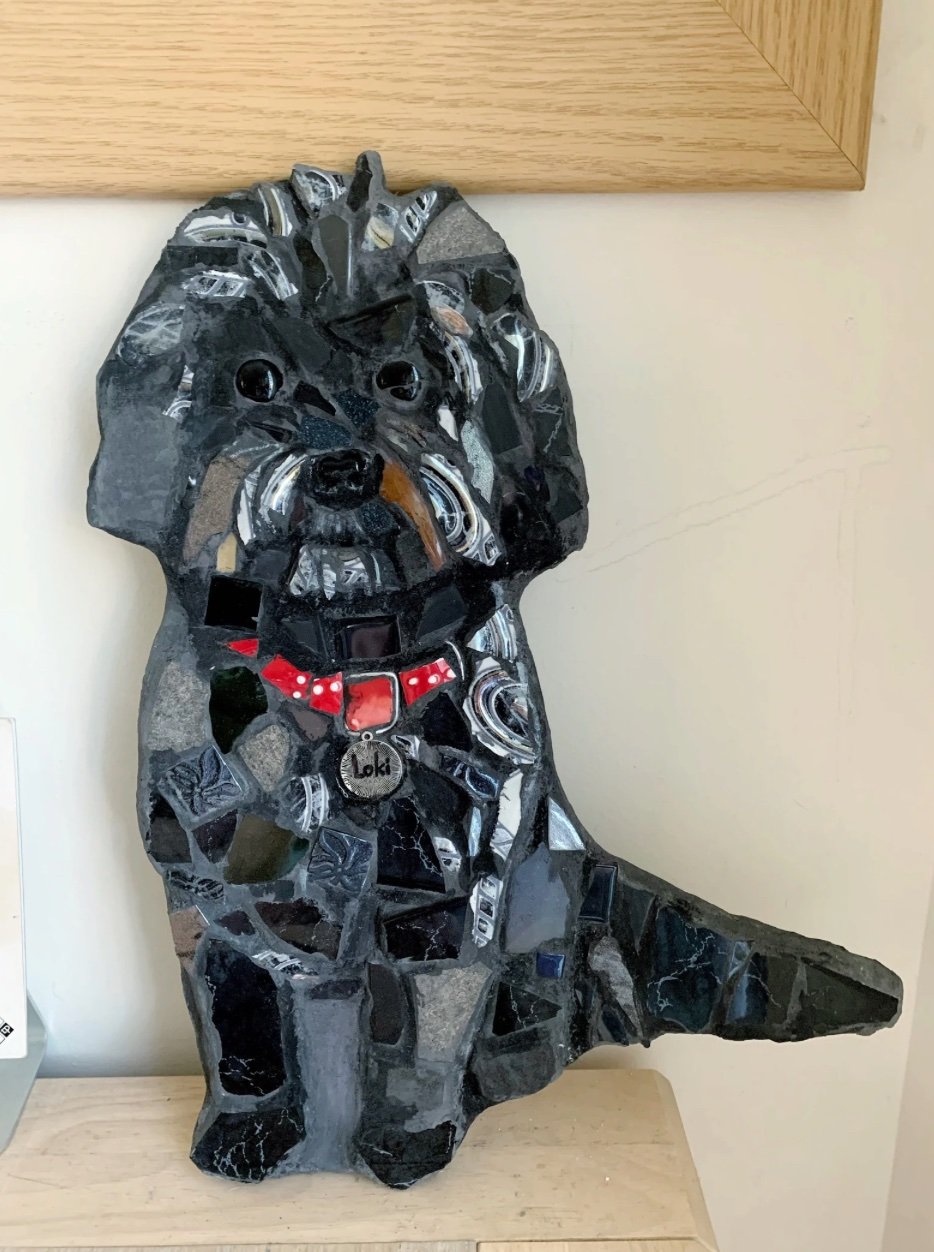 Mosaic portrait of a black cockapoo with a red collar