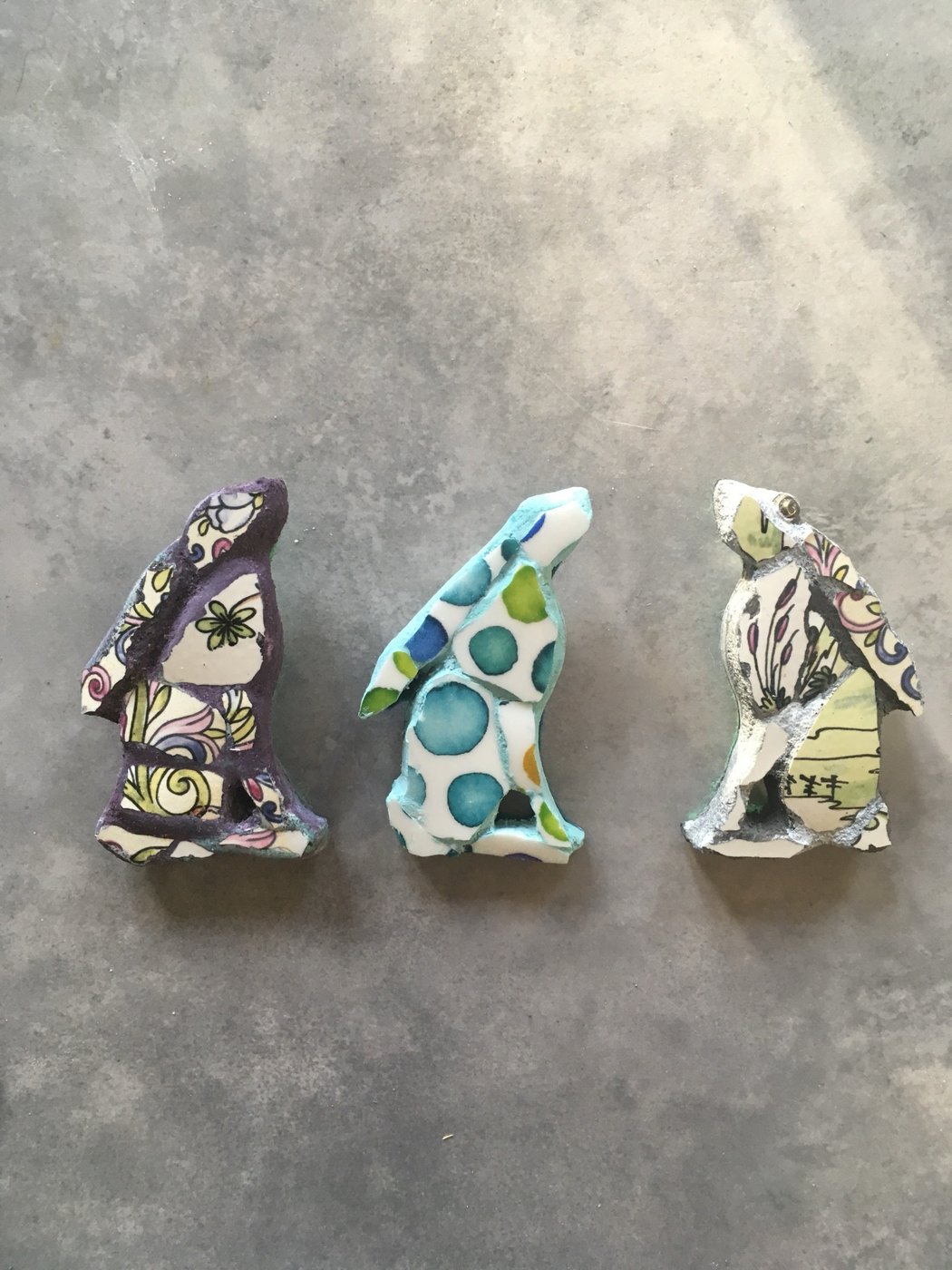 Three small mosaic rabbit shapes in patterned vintage china